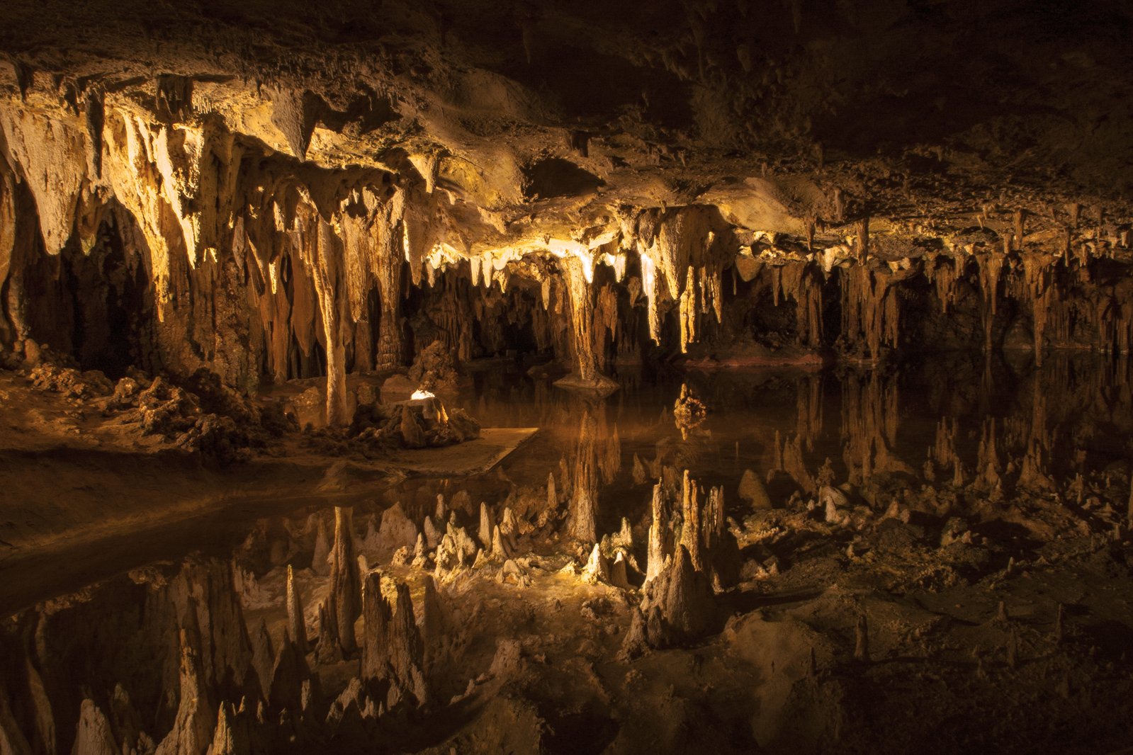 a cave with water and light reflecting off the surface