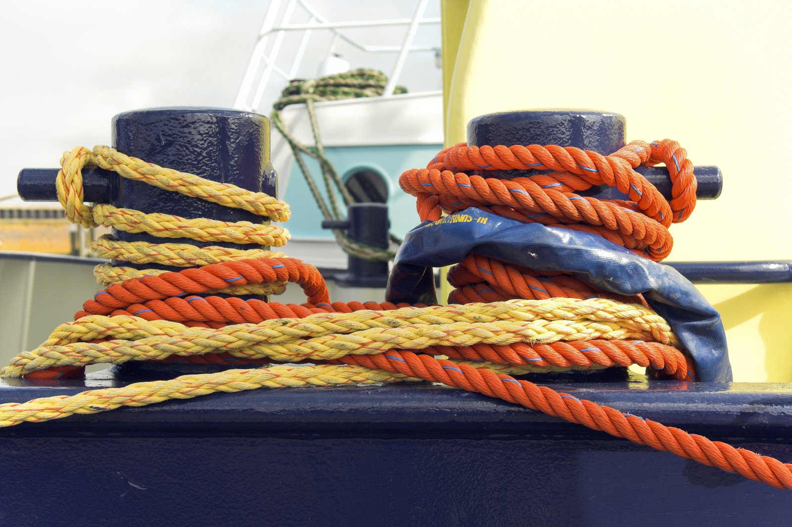 the ropes on a blue boat tied to it's poles