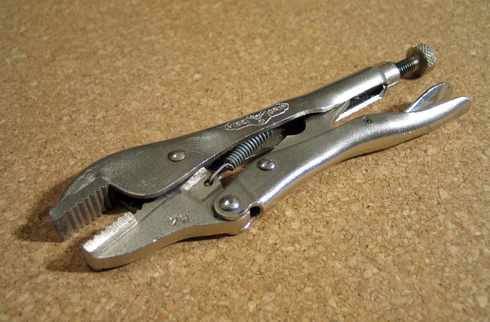 a metal pair of pliers with holes cut in half