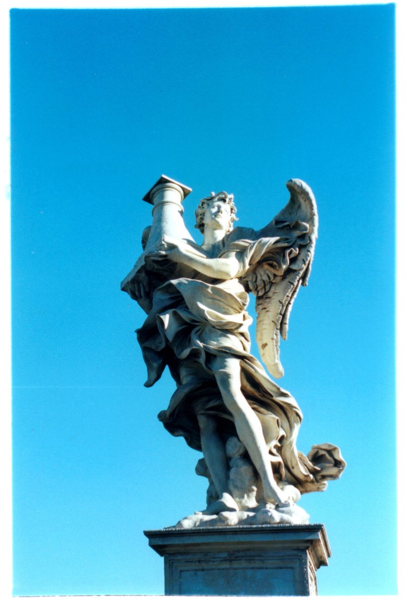 an ornate statue with two winged figures on top