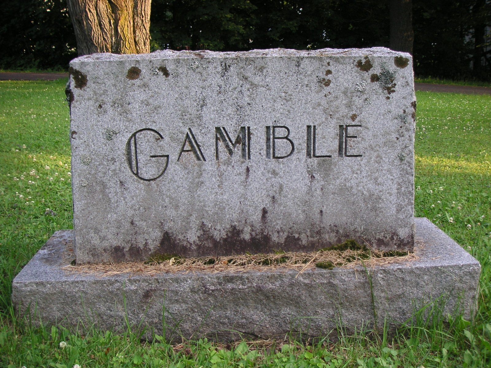 the grave marker is shown with graffiti on it