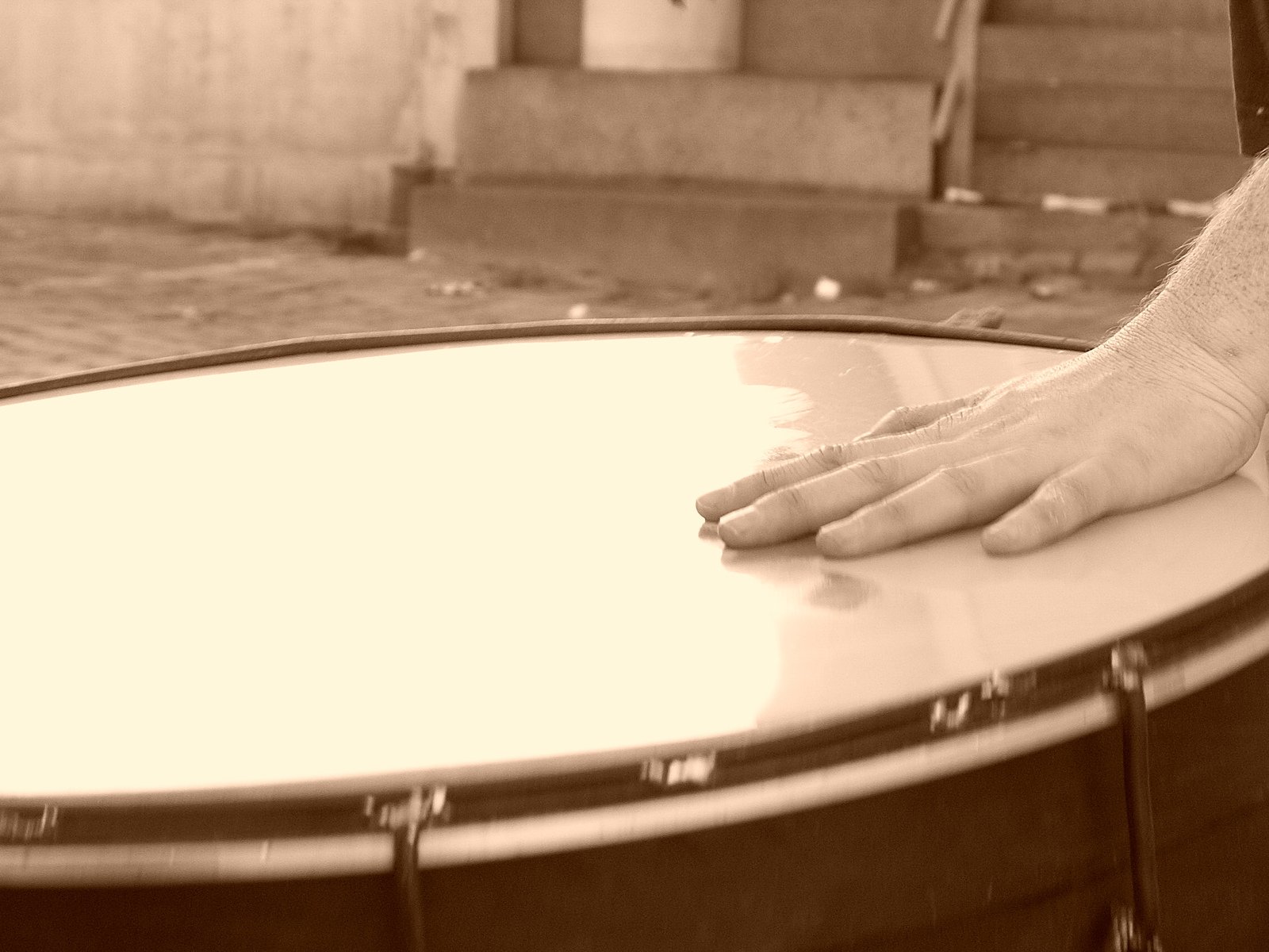 the foot of a person who is standing next to a drum