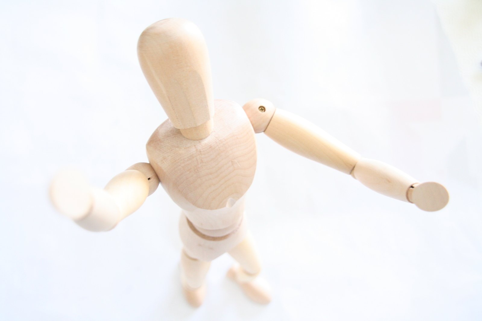 a doll with arm spread holding onto the leg