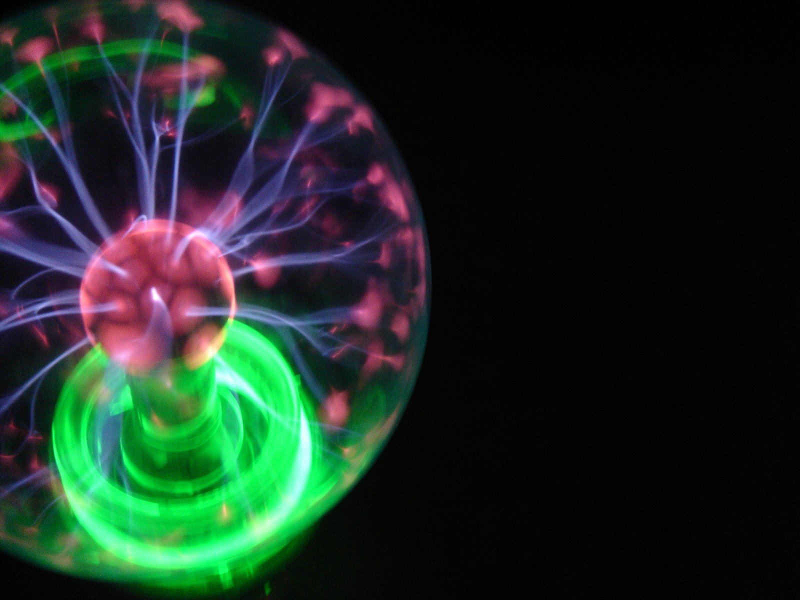 a spinning light up ball of green and purple