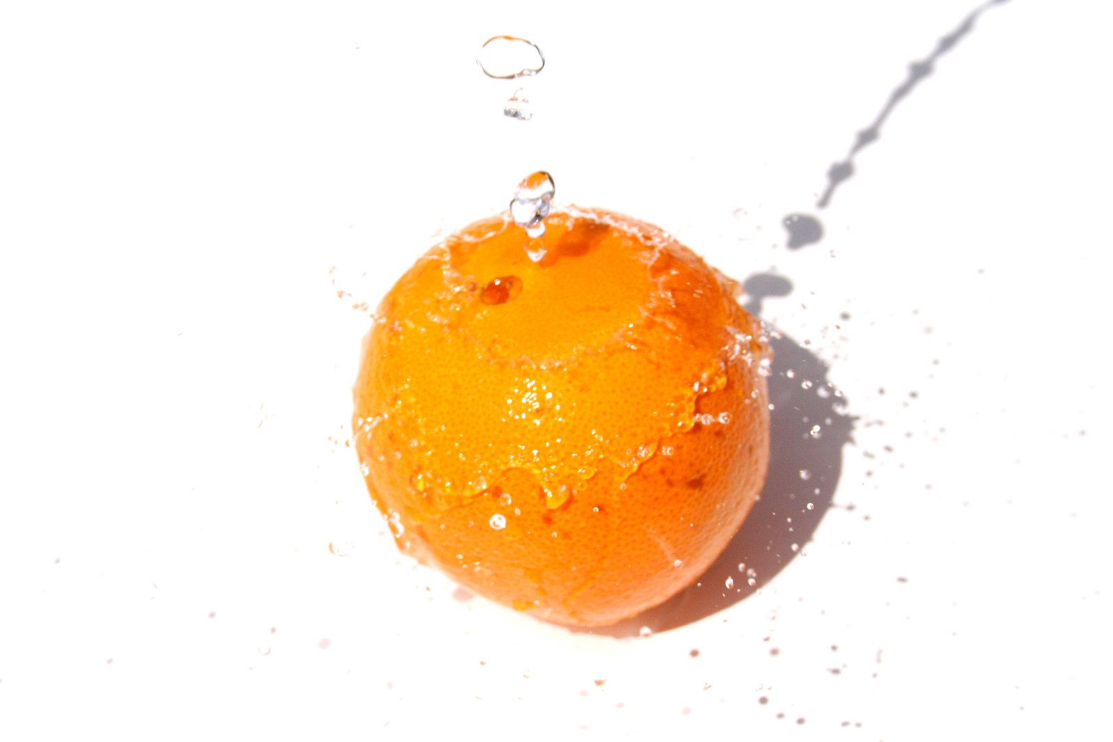 a fresh orange is laying in the snow with bubbles