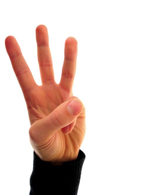 a person has a hand making the number four sign