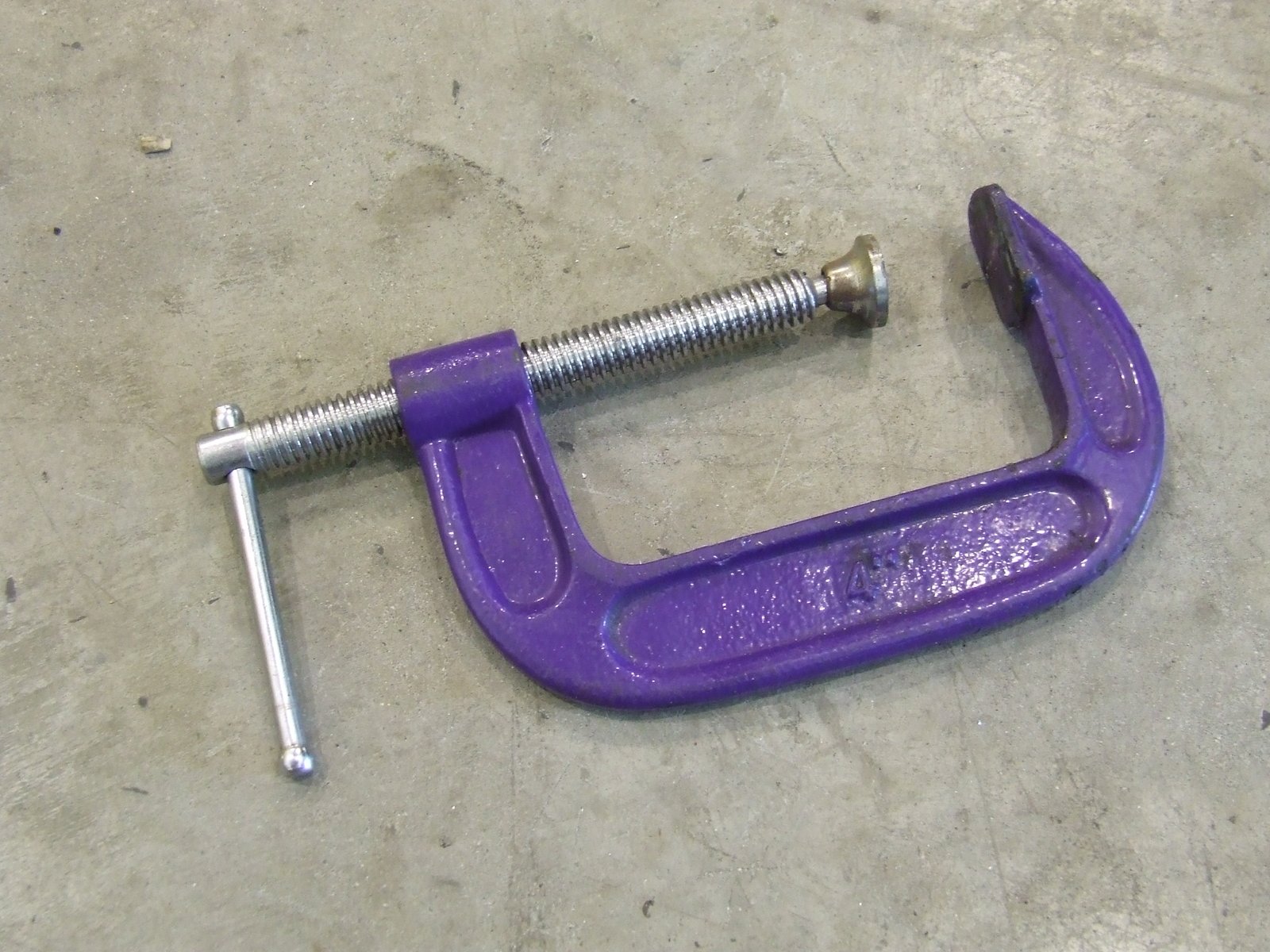 a purple tool sitting on top of cement