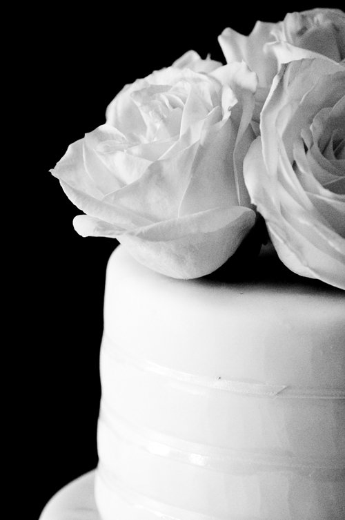 a close up po of some flowers on a white cake