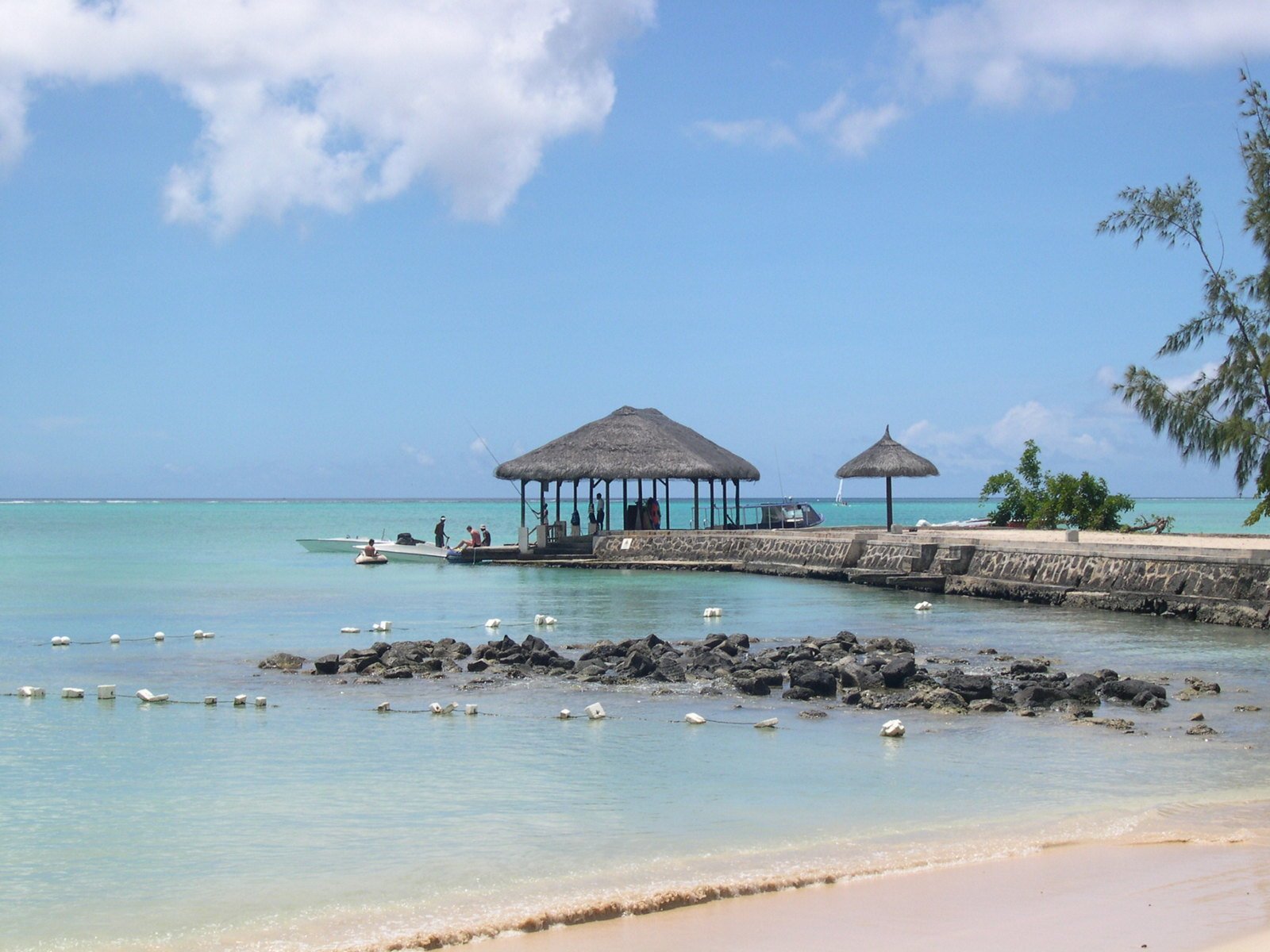 water at a beach with an ocean front hut