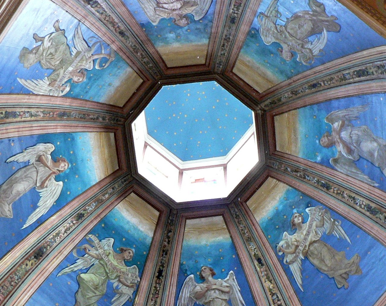 looking up at a painted ceiling inside of a building