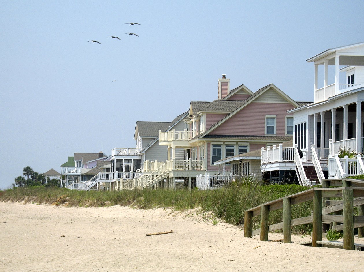the beach is lined with several large houses