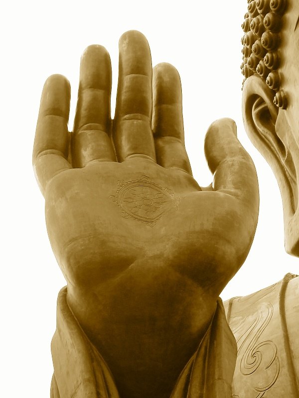 there is an artisticly detailed bronze statue with two hands together