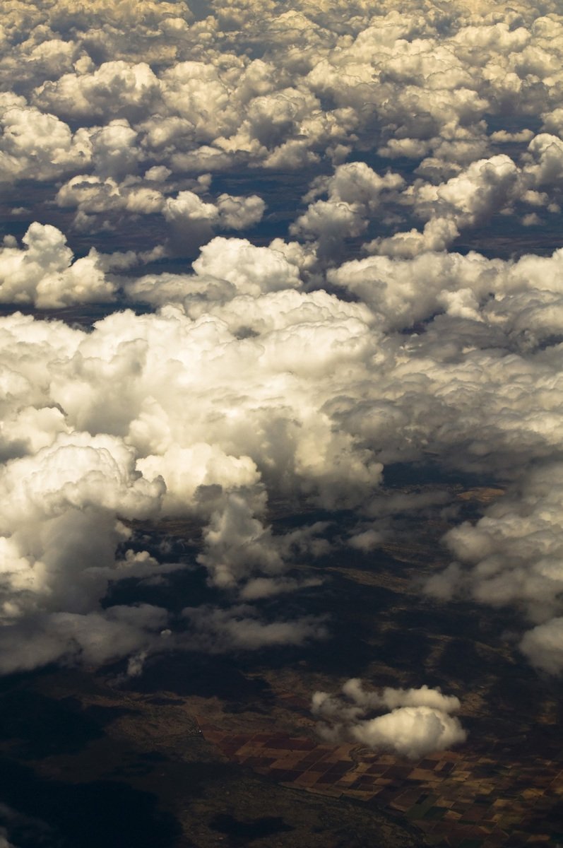 a cloudy sky seen from an airplane window