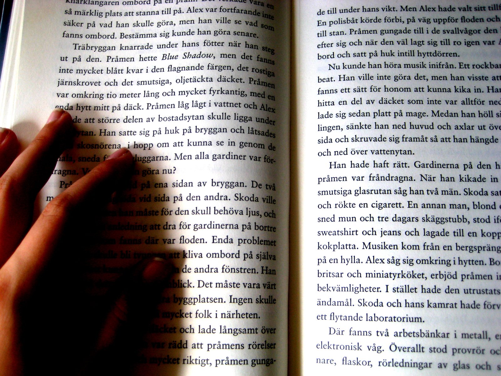 a person is reading a book with their fingers