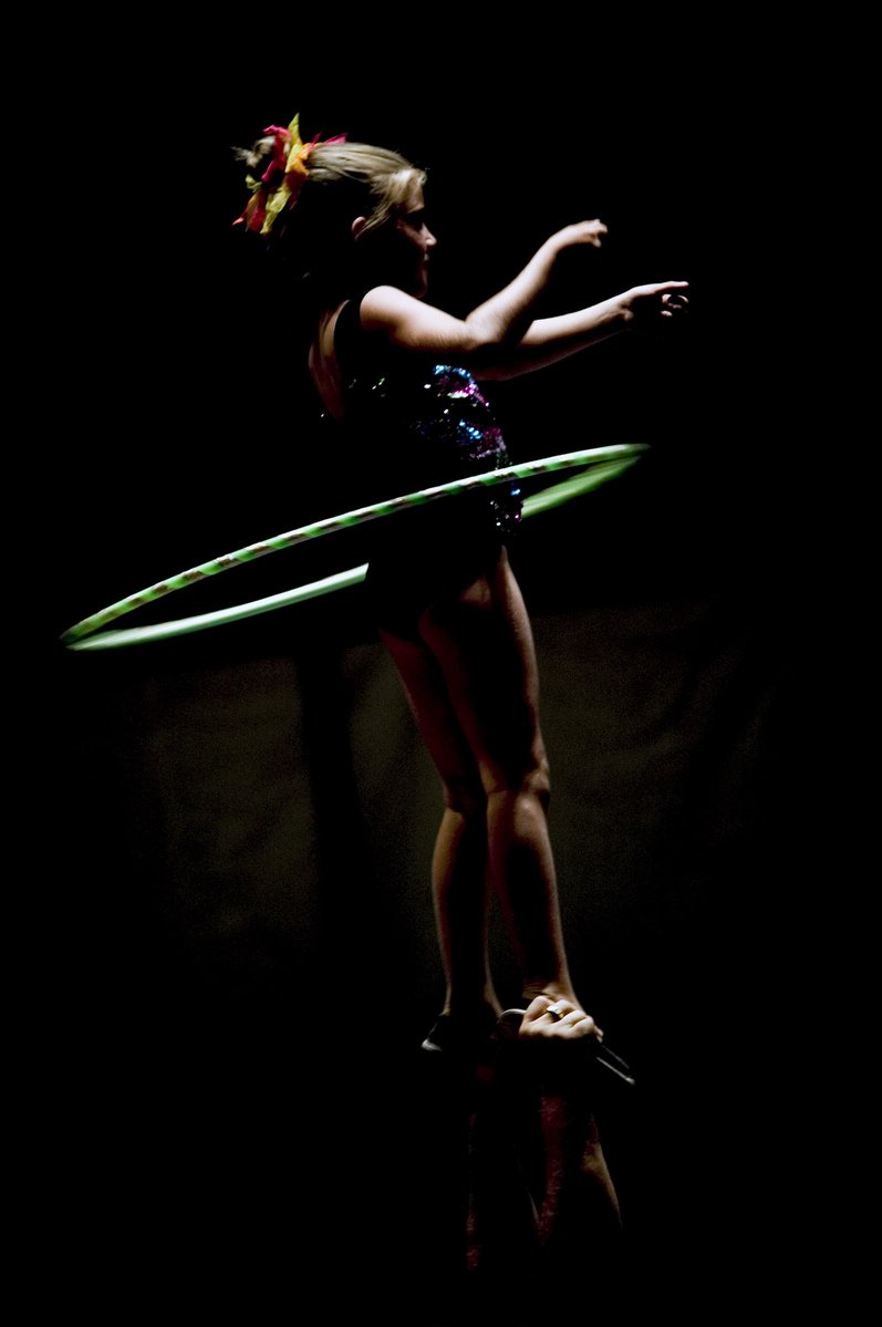 the girl is balancing on her surfboard