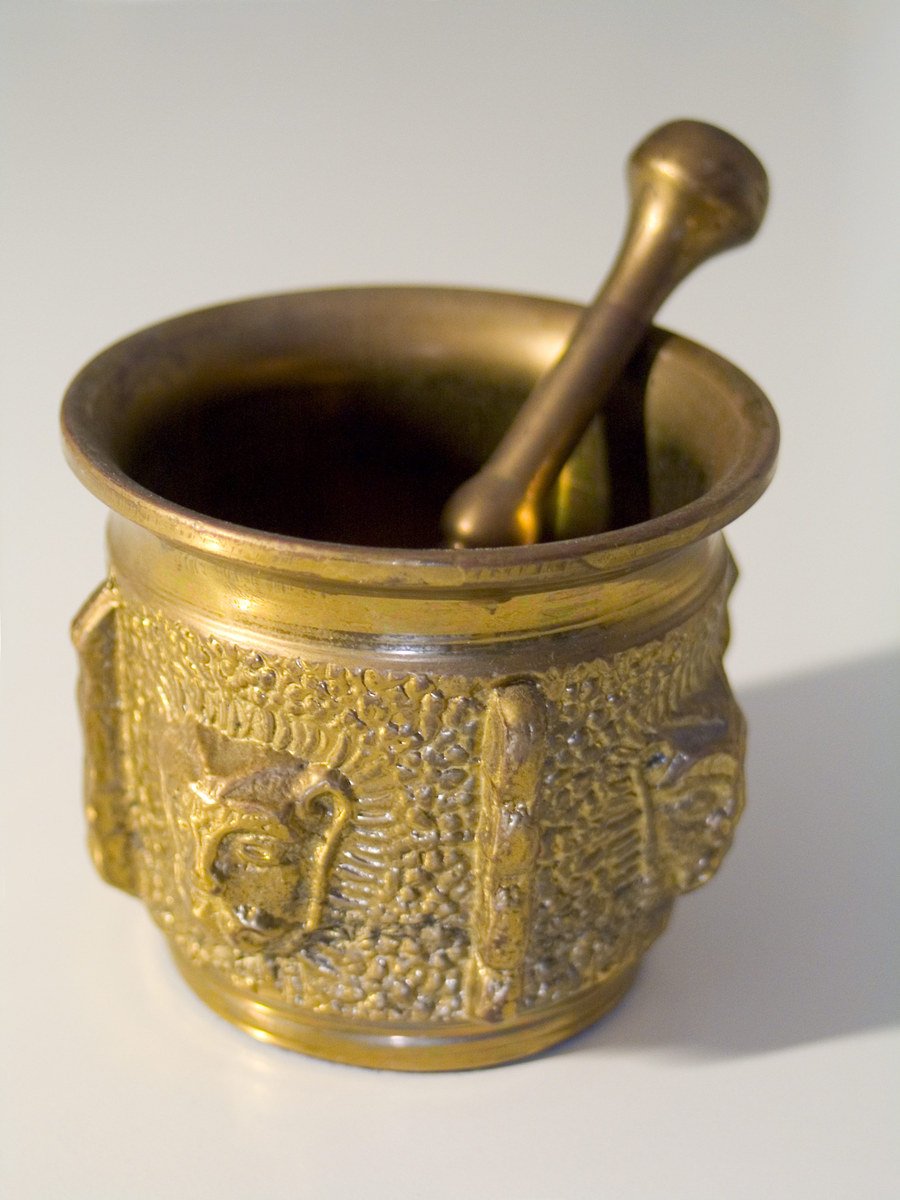 a small golden bowl on top of a white counter