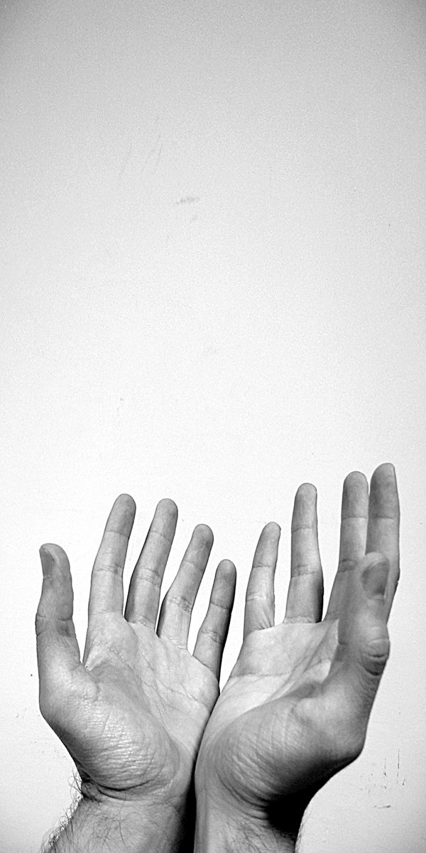 a man holding his hands up to the camera