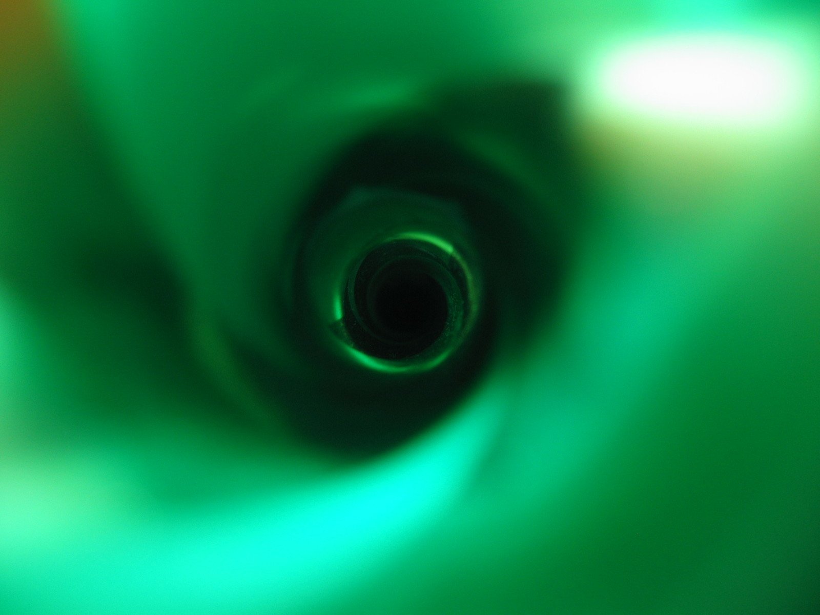 looking down at a green spiral shape made from a black pipe