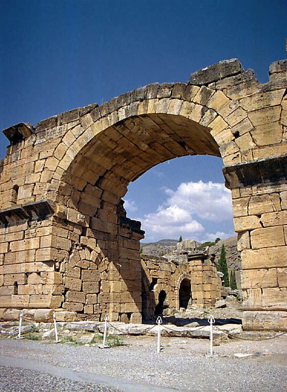 a brick arch in an old city that looks like it has been built in the time