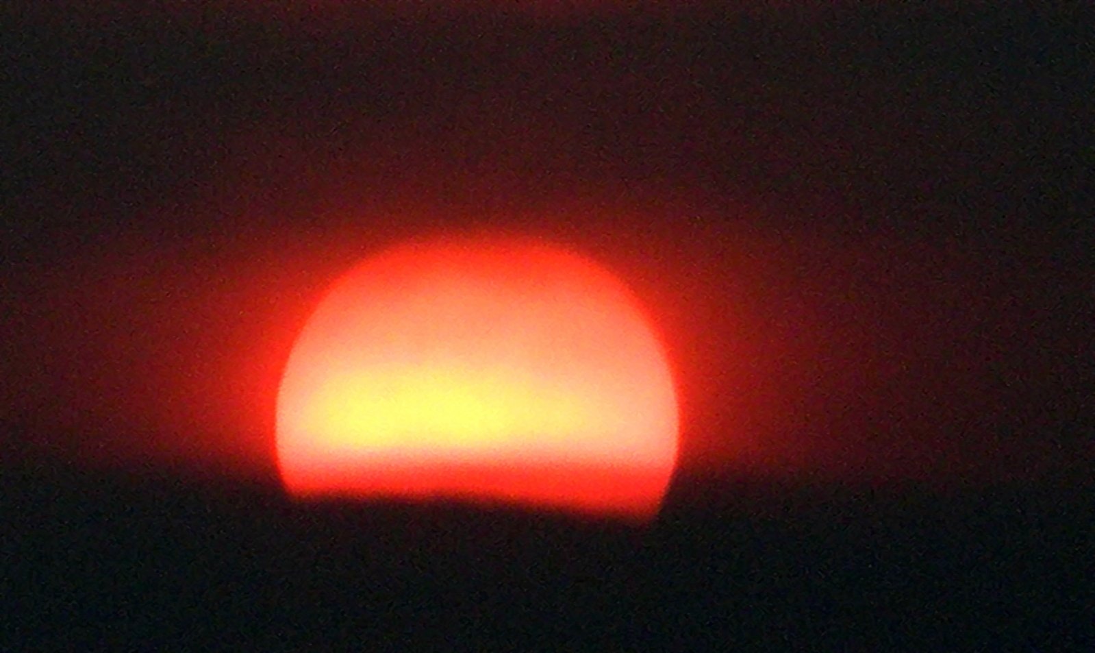 a close up view of the sun with clouds