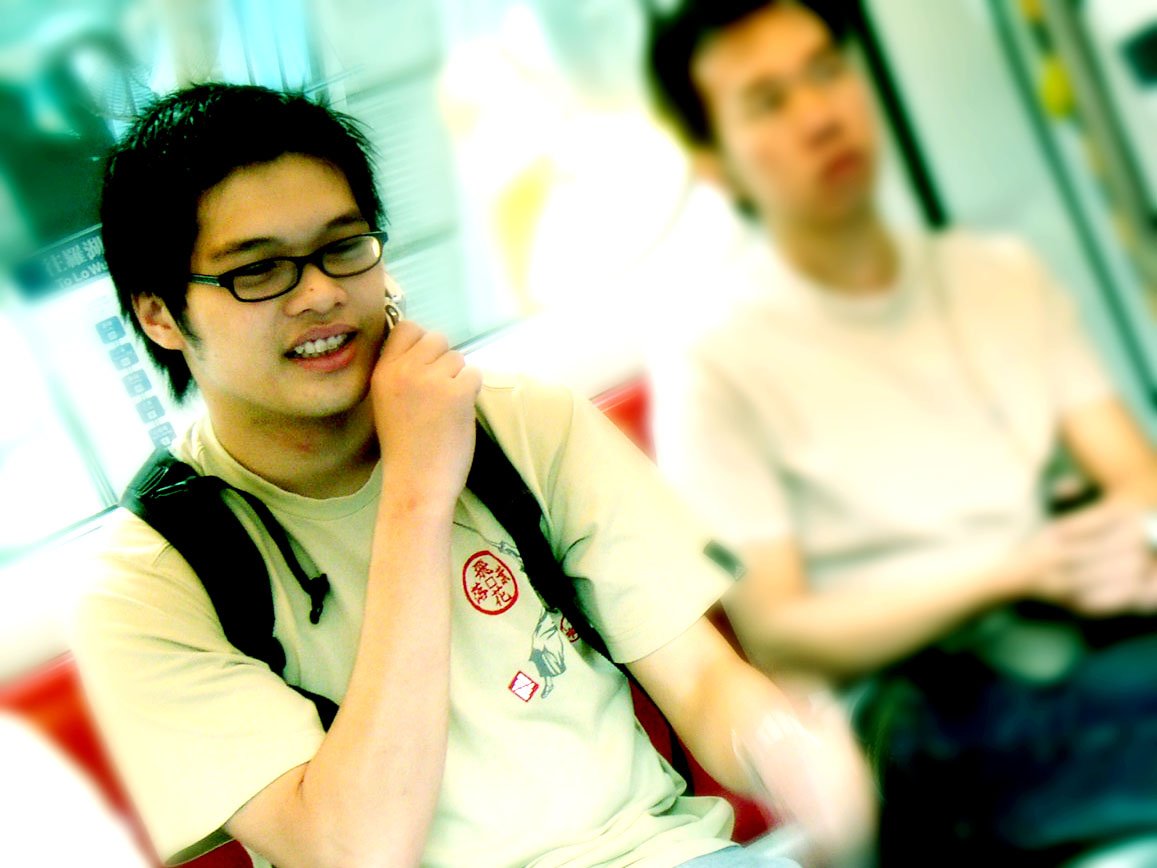 two young men riding public transportation on buses