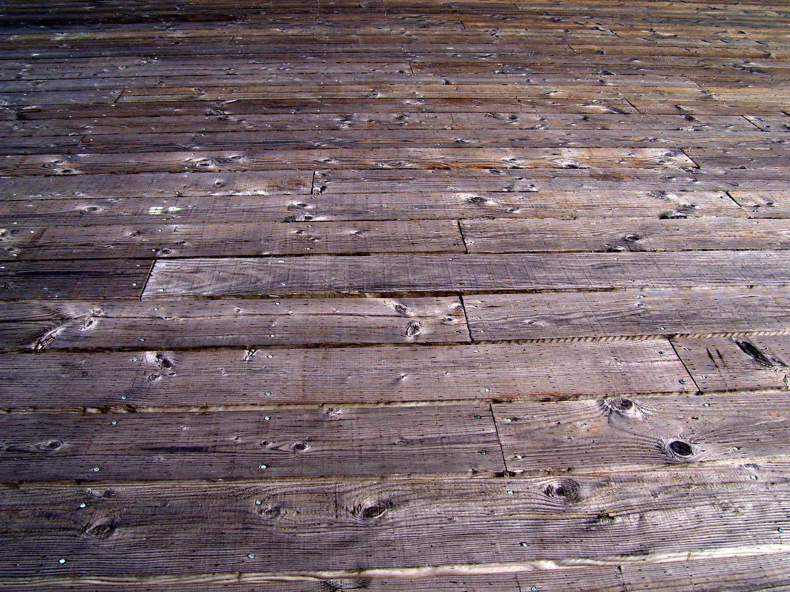 the top of the wooden floor shows very many scratches