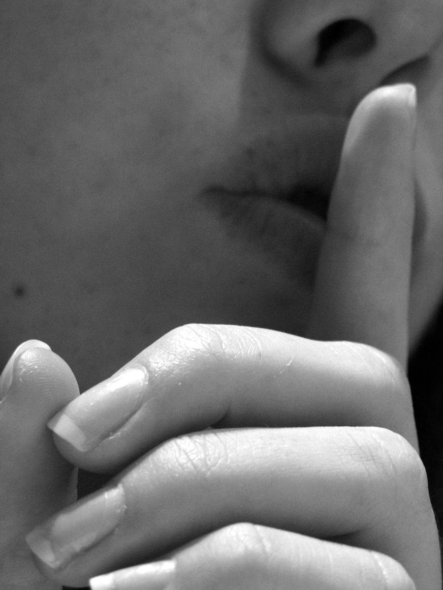 a woman holding her hand under her lip