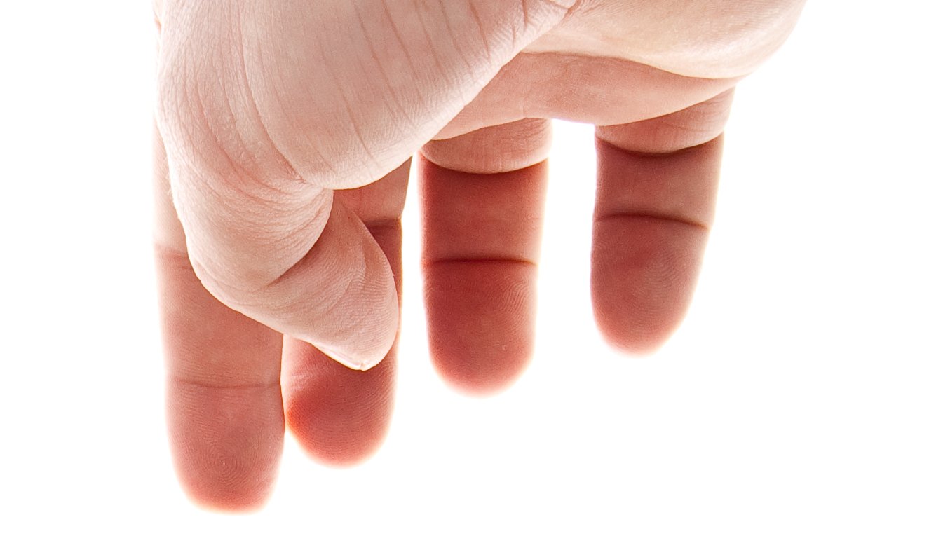 a person's hand holding up the tip of their finger