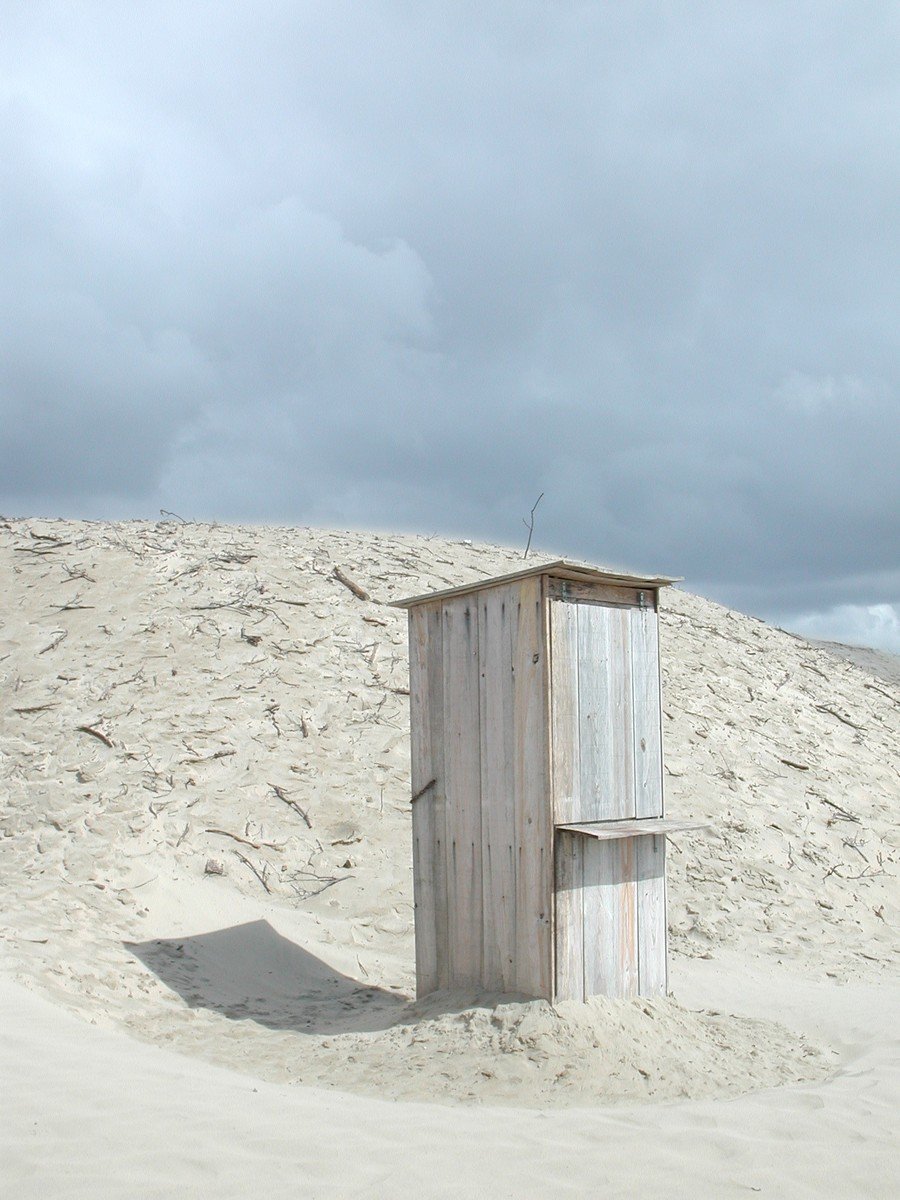 a piece of a building standing in the sand