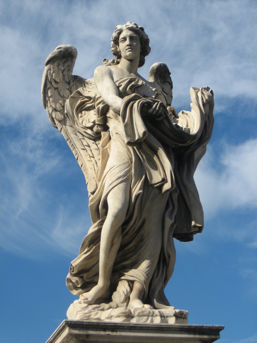 a white statue with a light pink top against a blue sky