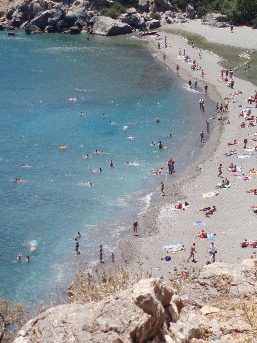 an image of a crowded beach near the water