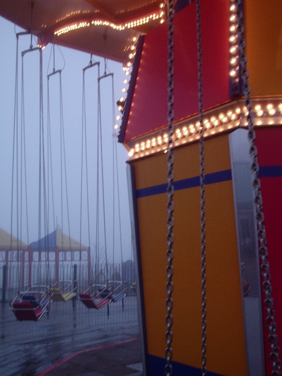 there is a carnival ride with swings and swings