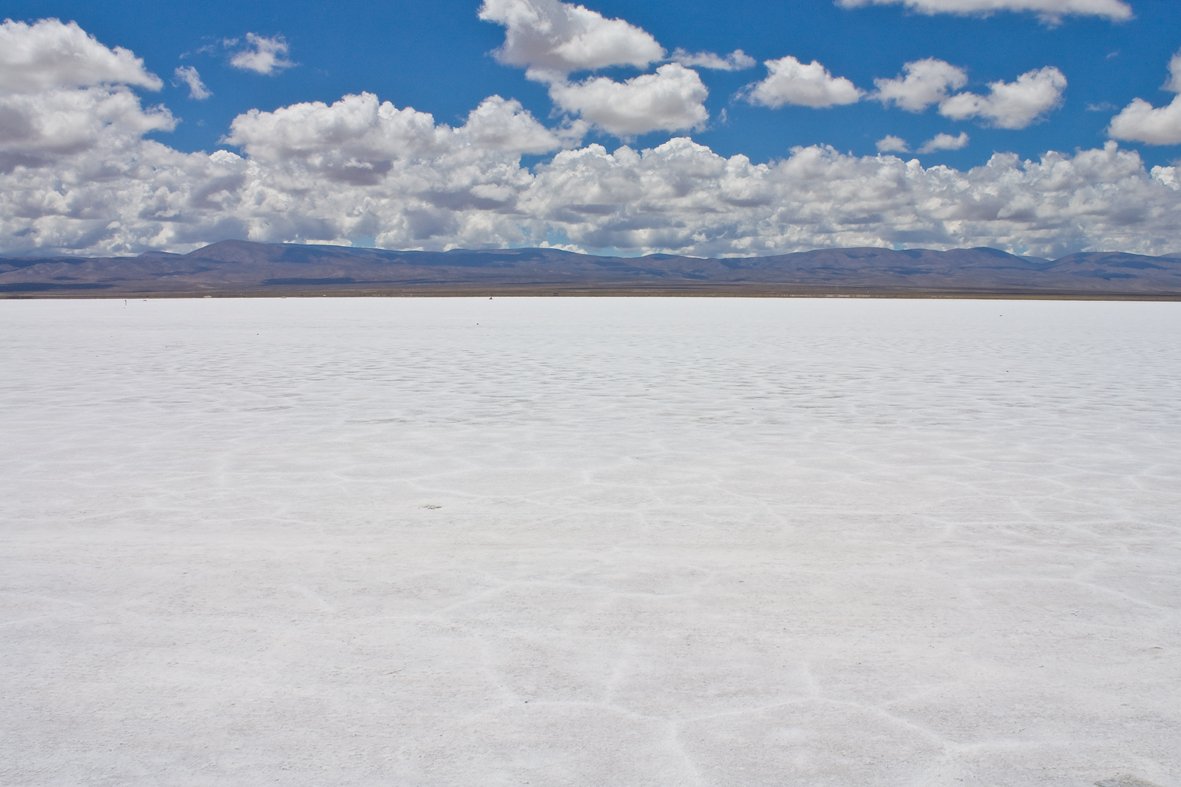 a blue sky is overcast and white sands