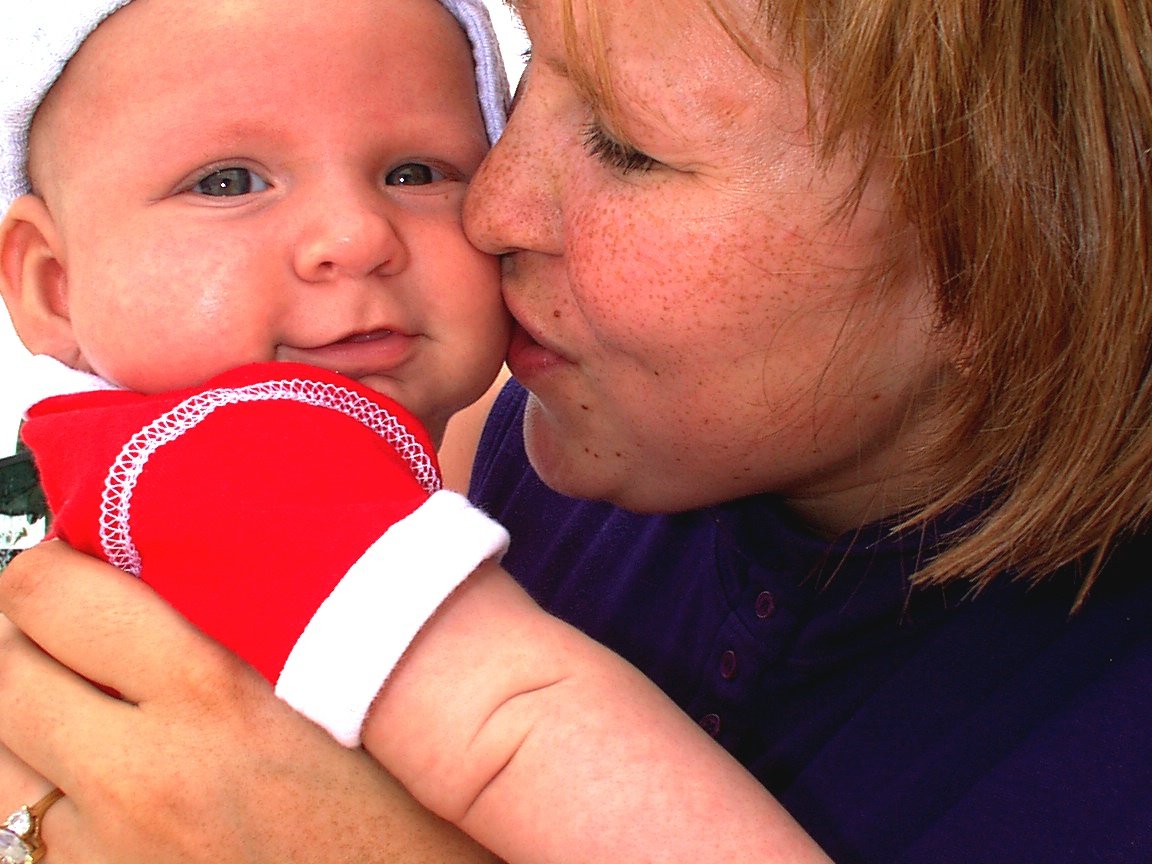 a women who is holding a baby in her arms