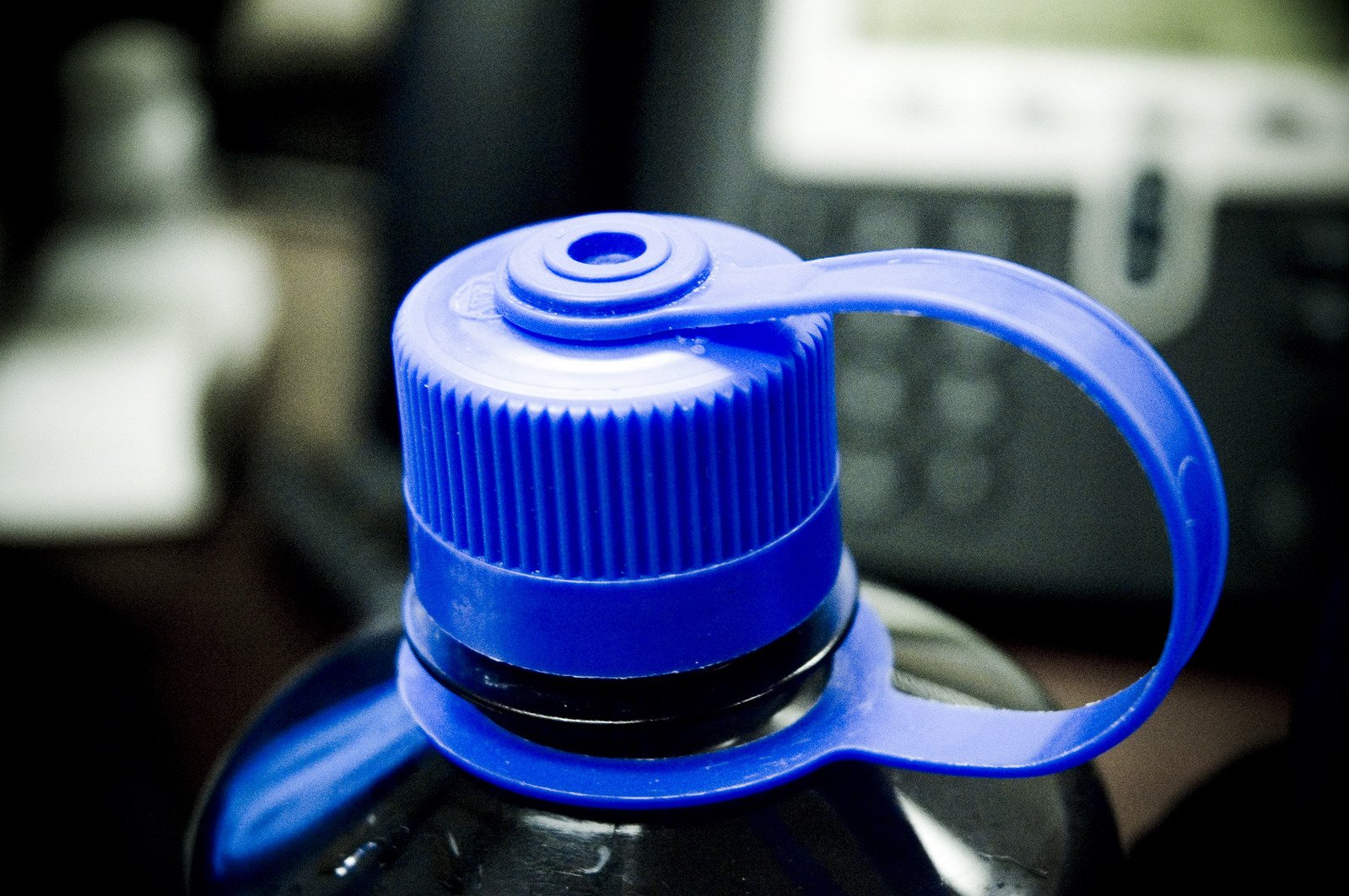 the bottom portion of a blue sports bottle