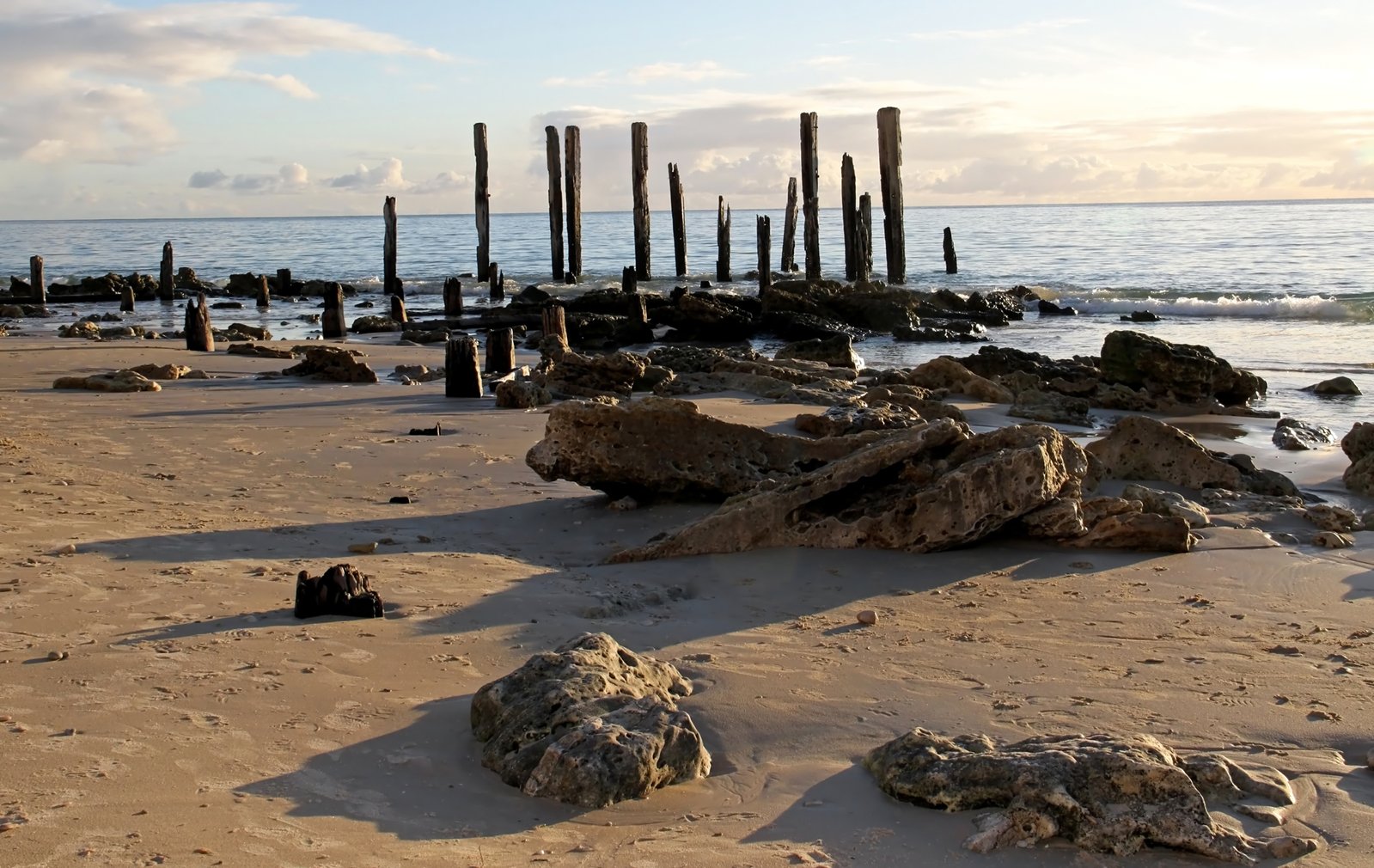 rocks on the beach are washed away from a water way