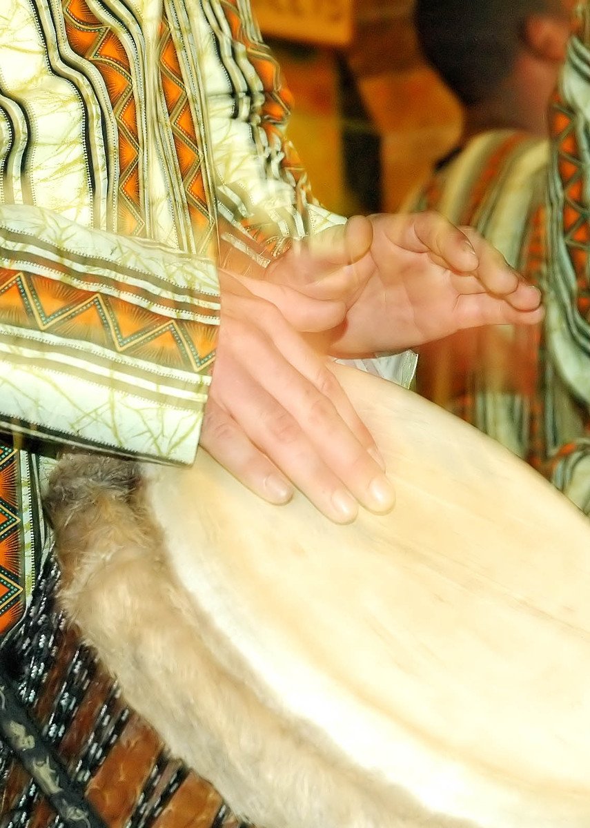 a person holding onto a large wooden drum