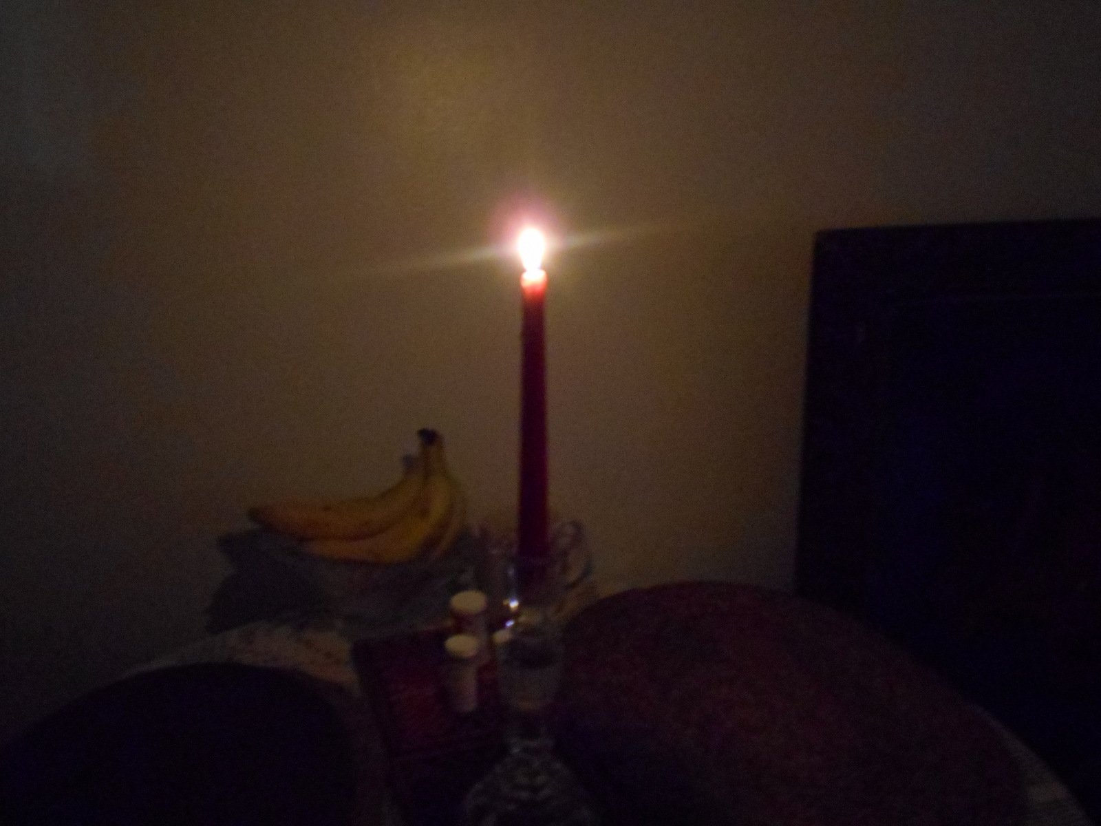 a table with two candles on it and a pillow