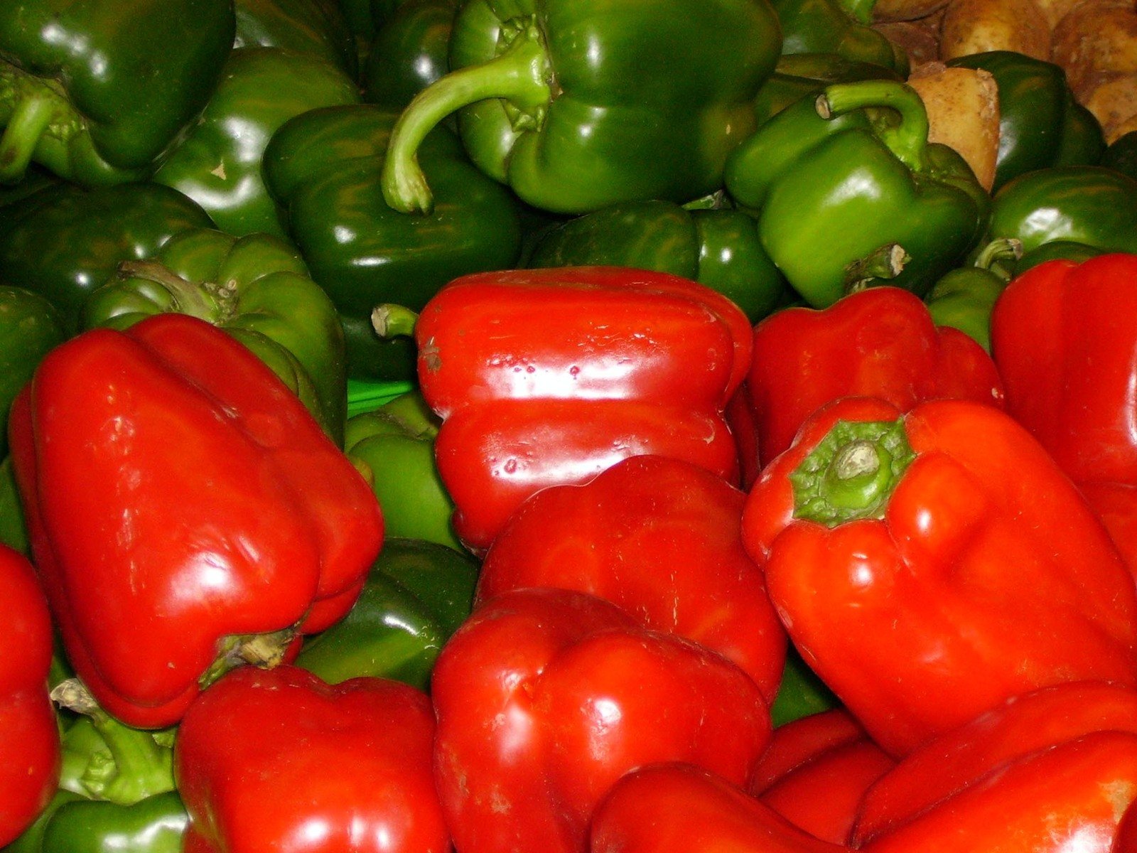 pile of different types of peppers together for sale