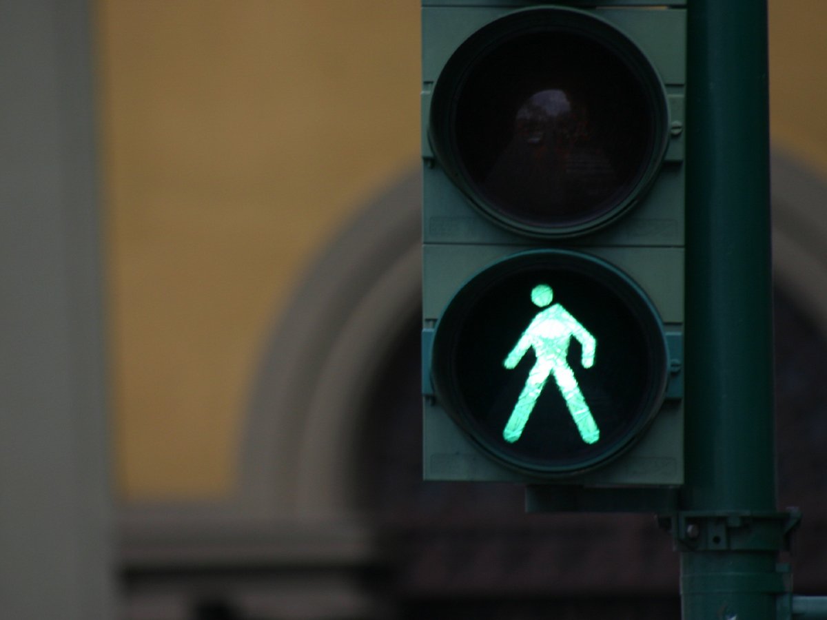 a traffic light with a green pedestrian light on the front