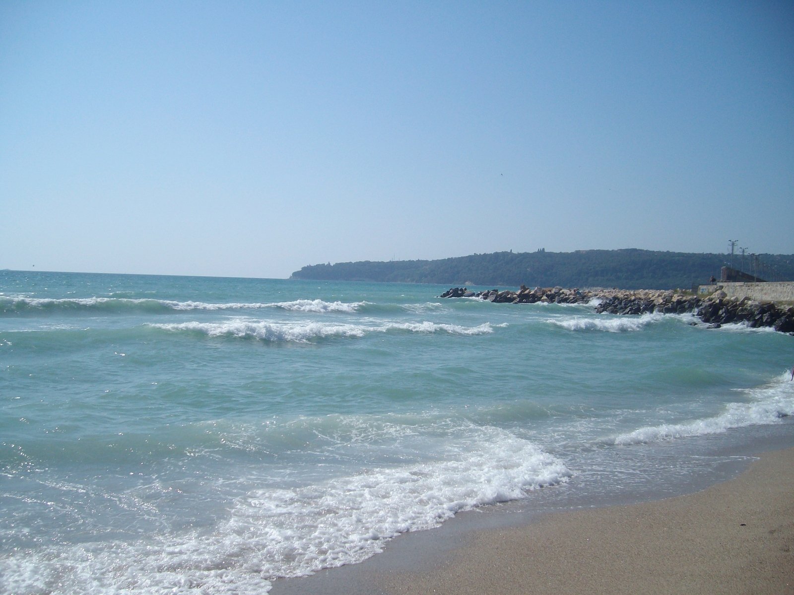 the beach is empty and there are waves coming up