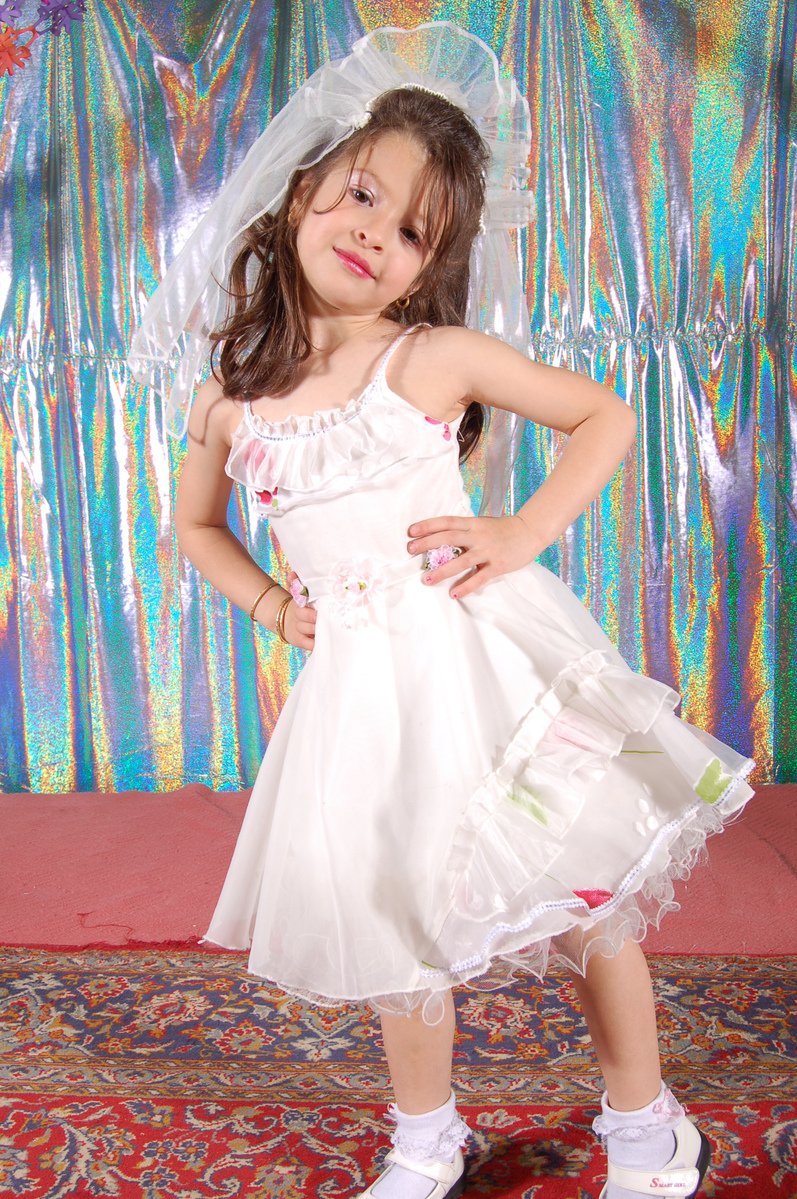 a girl wearing a dress and white shoes