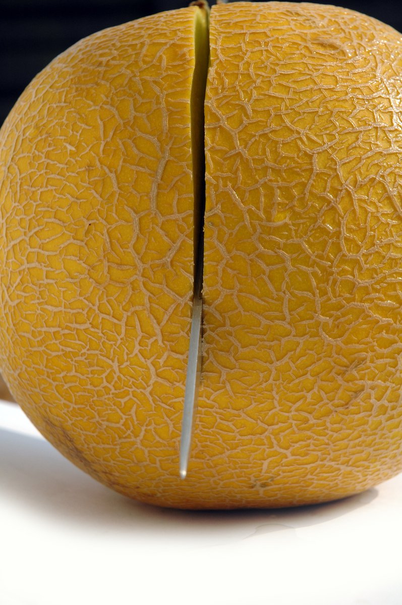 the large orange is cut in half and has no skin