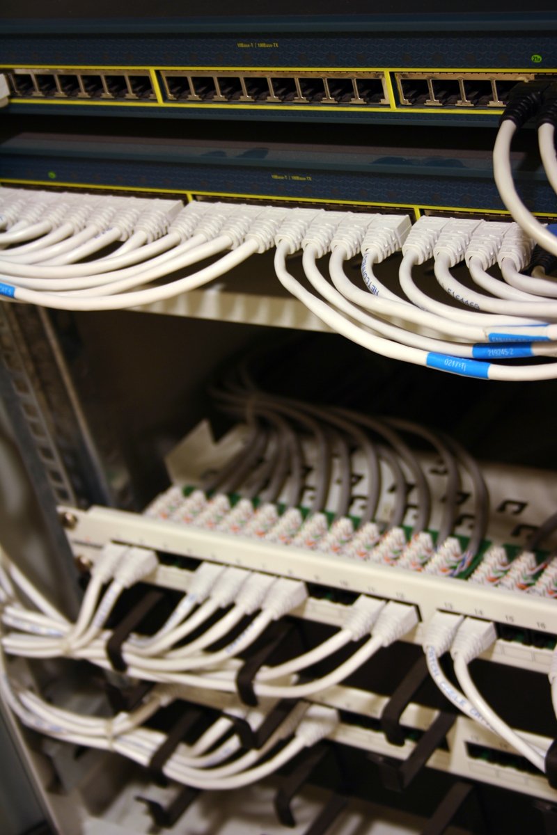 a rack with several wires and switches on it