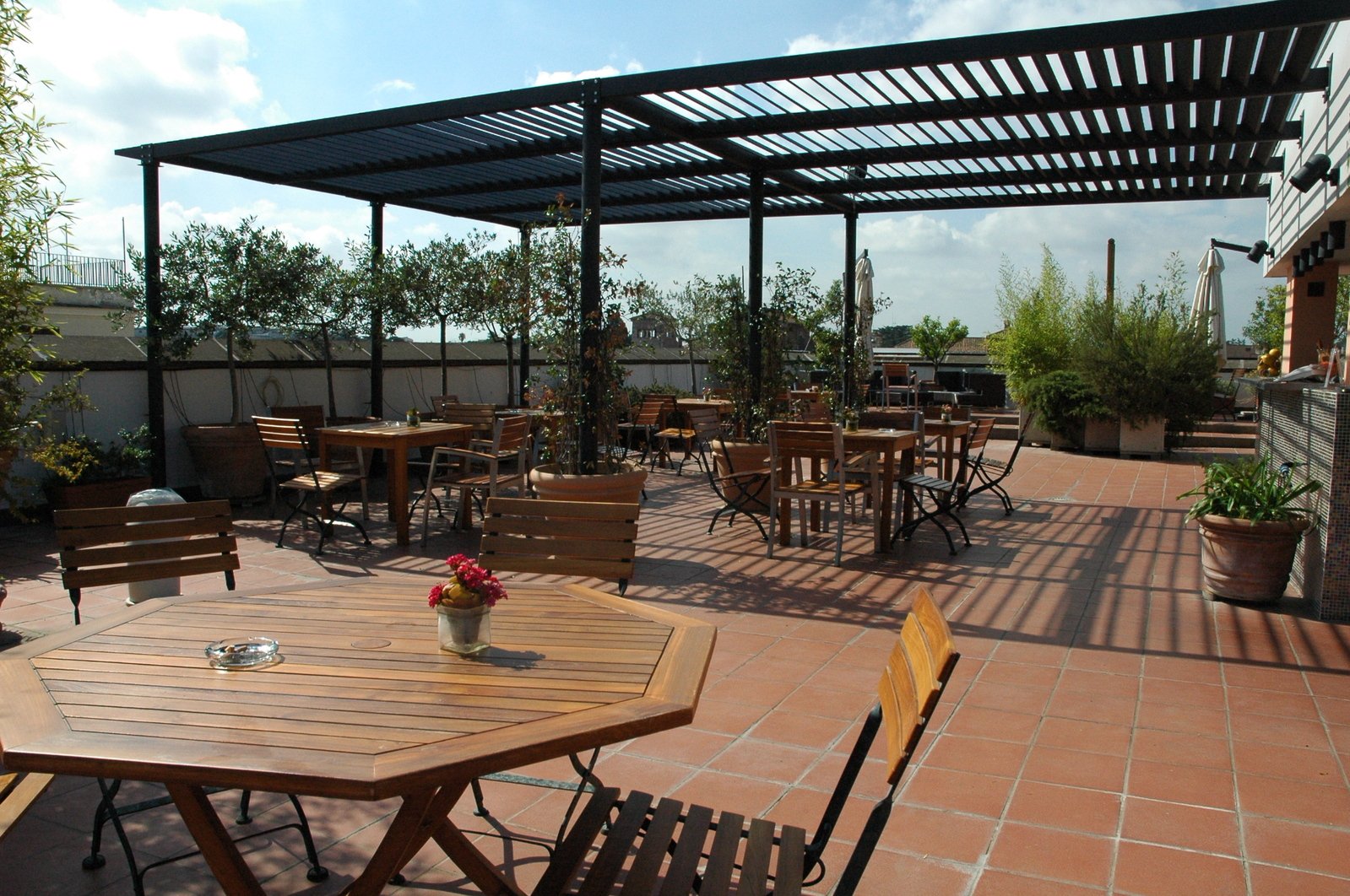 the patio is set up with an outside dining area and an attached terrace
