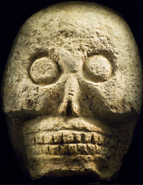 a carved head on display with an odd look