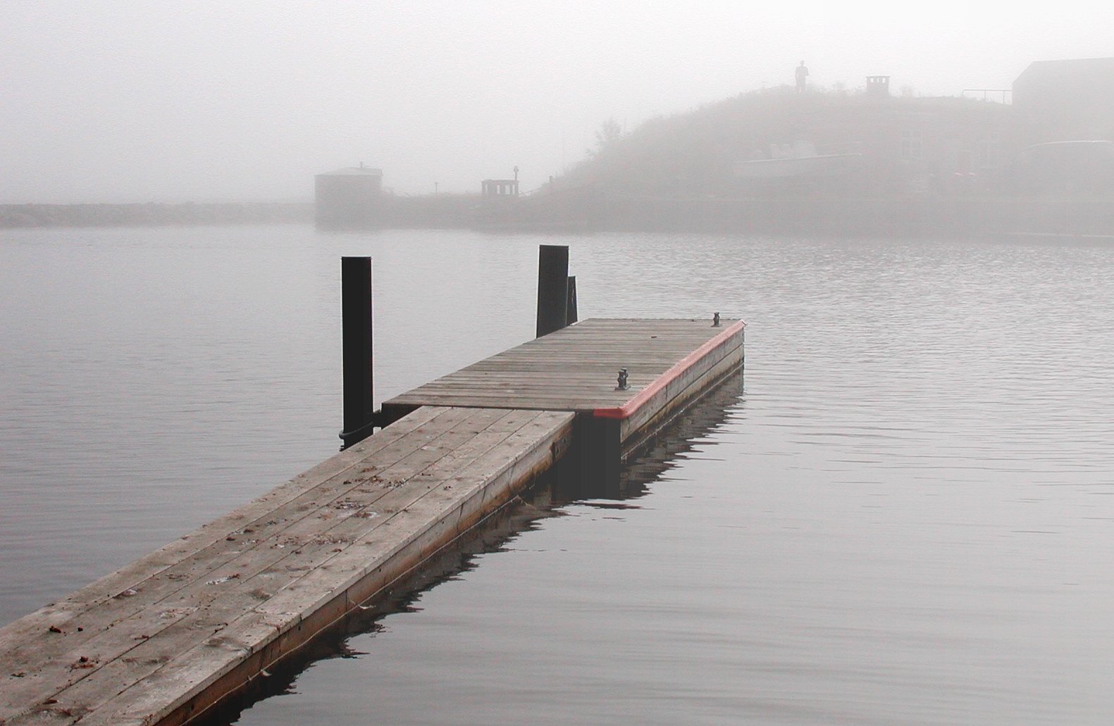 a dock sits at the end of a body of water