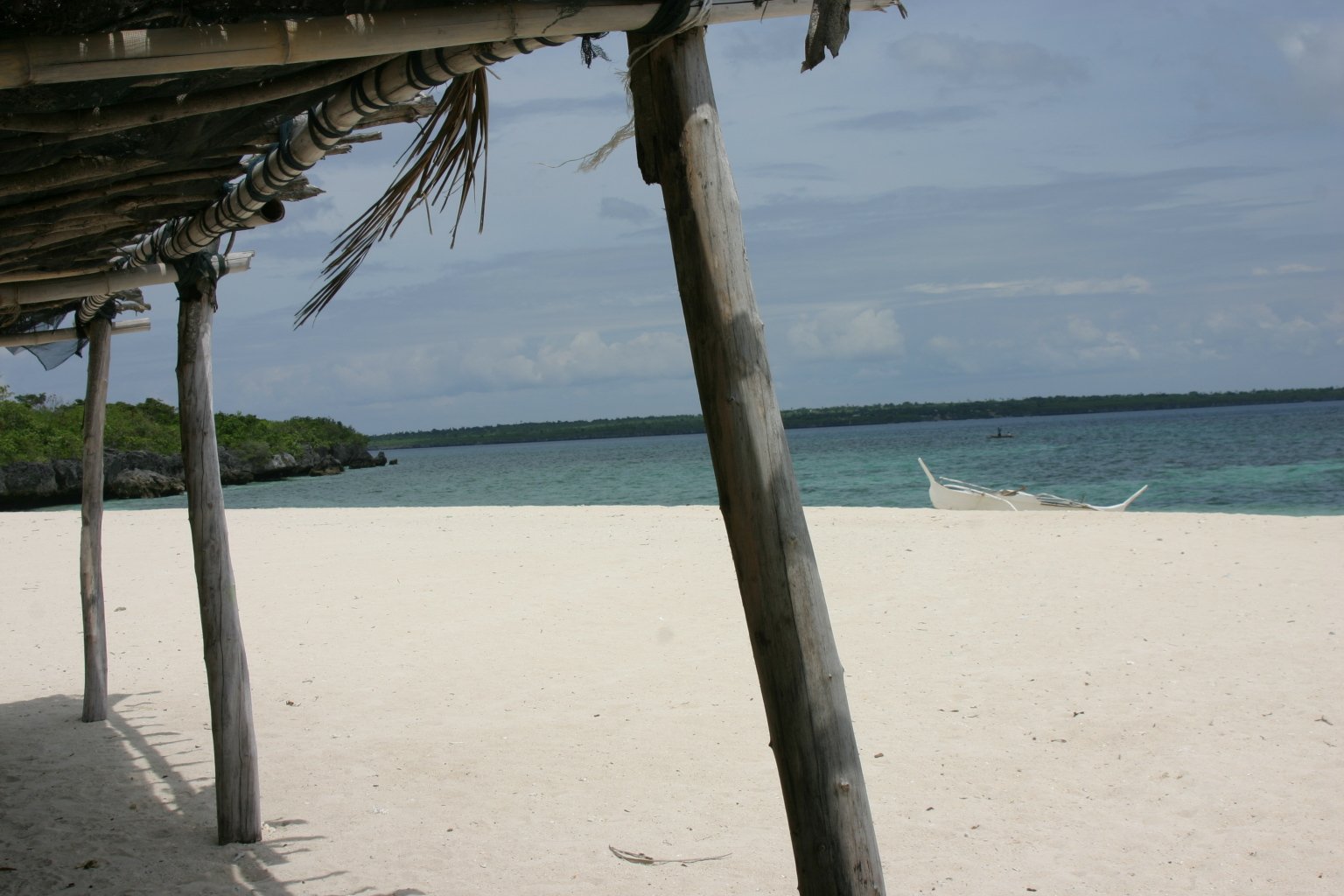 a beach covered in sand next to the ocean