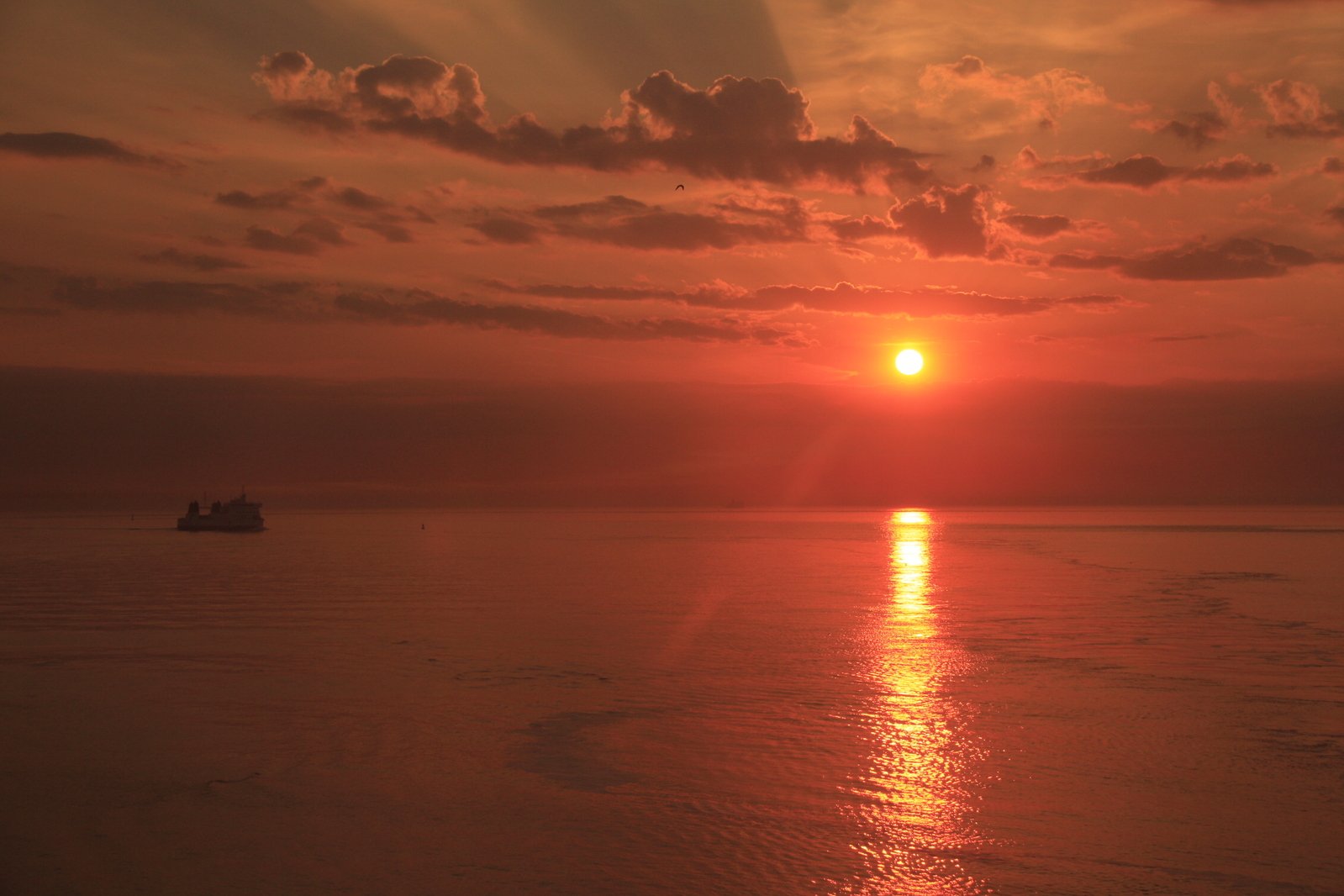 two boats on the water as the sun sets