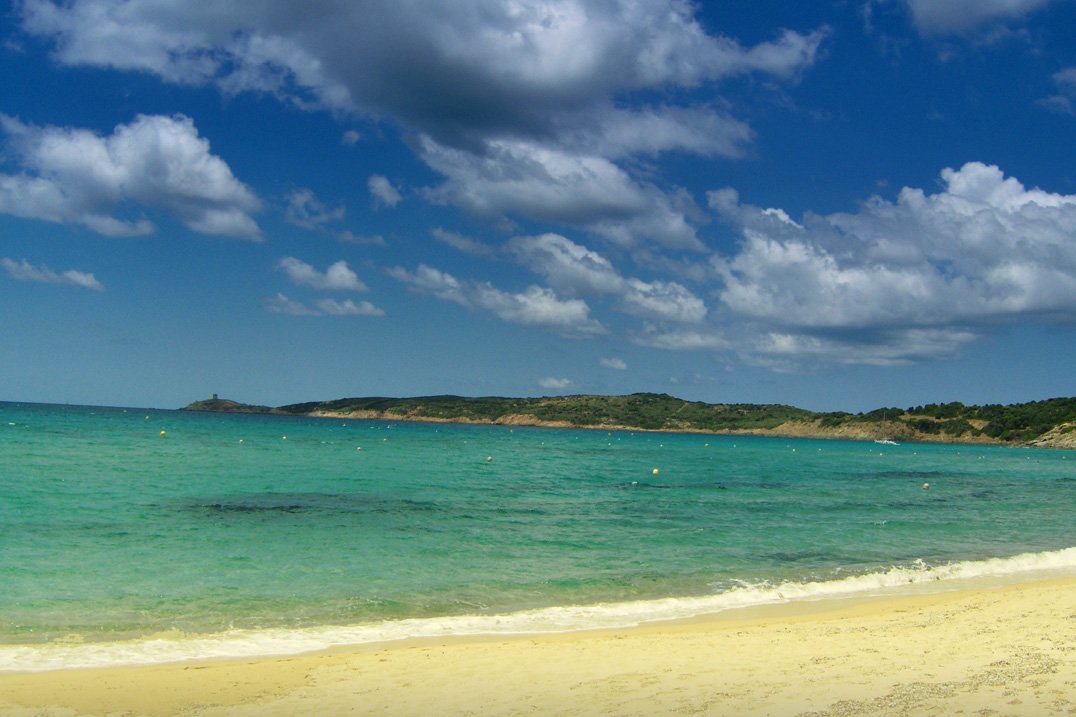 a body of water with clouds in the background